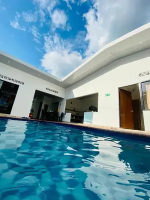 a swimming pool in a house with blue water at Casa piscina in Mariquita