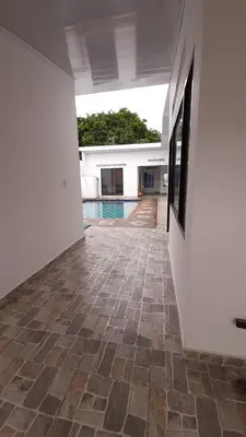 a hallway with a tile floor and a swimming pool at Casa piscina in Mariquita
