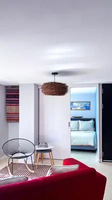 a living room with a couch and a table and a bed at Casa Dodo Guatapé in Guatapé