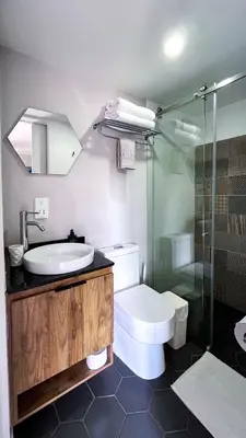 a bathroom with a sink and a toilet and a shower at Casa Dodo Guatapé in Guatapé