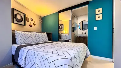 a bedroom with a bed and a blue wall at Casa Dodo Guatapé in Guatapé