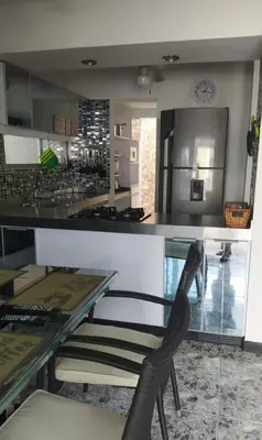 a dining room with a glass table and a counter at cabaña en san jeromino in San Jerónimo