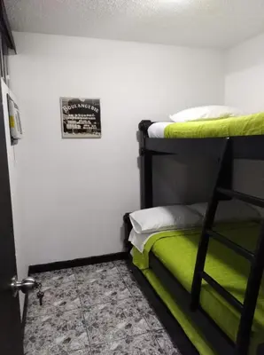 a bedroom with a bunk bed with a green mattress at cabaña en san jeromino in San Jerónimo