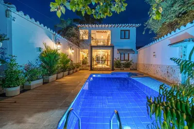 a swimming pool in front of a house at night at Casa Bixa Hotel Boutique -Santa Fe de Antioquia- Mayores de 12 años in Santa Fe de Antioquia