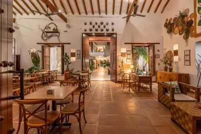 a restaurant with tables and chairs in a room at Casa Bixa Hotel Boutique -Santa Fe de Antioquia- Mayores de 12 años in Santa Fe de Antioquia