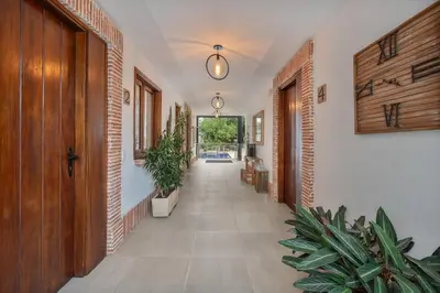 a hallway with plants and a hallway with at Casa Bixa Hotel Boutique -Santa Fe de Antioquia- Mayores de 12 años in Santa Fe de Antioquia