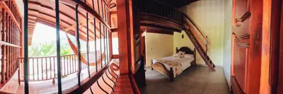 a room with a bed and a large window at La Casa de las Flores Hostal in Jardin