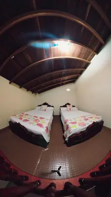 two beds are sitting in a room with at La Casa de las Flores Hostal in Jardin