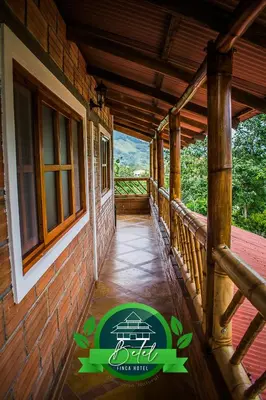 a porch of a house with a sign on it at Finca Hotel Betel in San Carlos