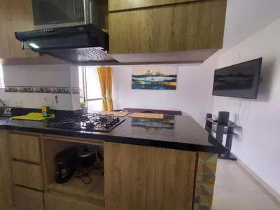 a kitchen with a counter and a stove top oven at Apartamento Boston - Downtown - 2 hab - Wifi in Medellín