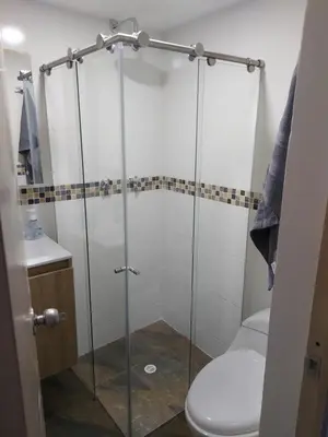 a bathroom with a glass shower with a toilet at Apartamento Boston - Downtown - 2 hab - Wifi in Medellín