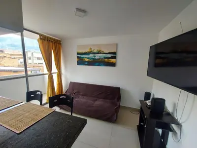 a living room with a couch and a television at Apartamento Boston - Downtown - 2 hab - Wifi in Medellín