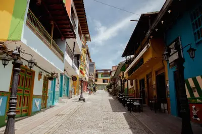 an empty street in an old town with colorful buildings at Hotel Casa Verde Guatapé in Guatapé
