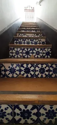 a set of stairs with blue and white tiles at Villa del Prado in Medellín