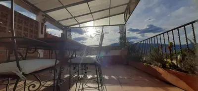 a balcony with a table and chairs on a balcony at Villa del Prado in Medellín