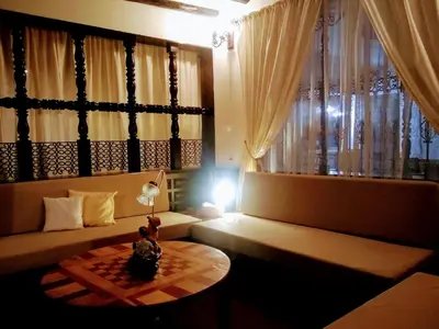 a living room with a couch and a table and a window at Villa del Prado in Medellín