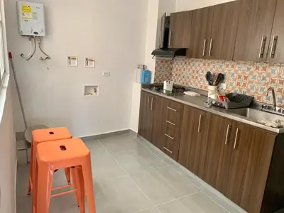 a kitchen with an orange stool in a kitchen at Charming apartment in downtown – Home ARIS 301 in Medellín