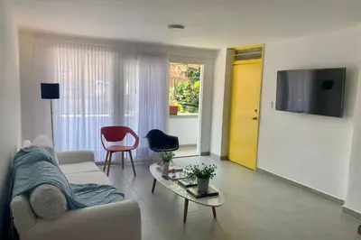 a living room with a white couch and a table at Charming apartment in downtown – Home ARIS 301 in Medellín