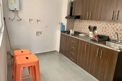 a kitchen with an orange stool in a kitchen at Charming apartment in downtown – Home ARIS 301 in Medellín