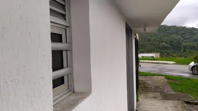 a window of a white building with a view of a street at Apartamento-Habitación Palonegro Manizales in Manizales