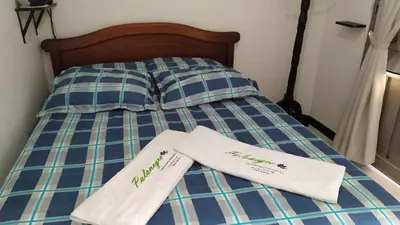 two towels sitting on top of a bed at Apartamento-Habitación Palonegro Manizales in Manizales