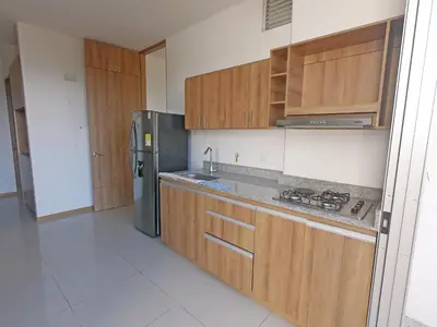 a kitchen with wooden cabinets and a stainless steel refrigerator at Hermoso Apartamento en San Jerónimo 3 Habitaciones PS121 in San Jerónimo