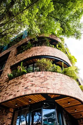 a brick building with plants on top of it at Nomada Hotel Origen in Medellín
