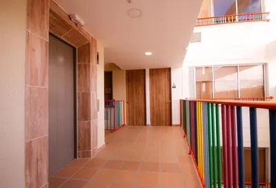 a hallway with a colorful staircase in a house at Aptos y Apartaestudios frente al Malecón y el Embalse, Zona Gastronómica, a 8 minutos de la Piedra del Peñol, TODO CERCA!!! in Guatapé