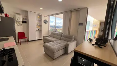 a living room with a couch and a chair at Aptos y Apartaestudios frente al Malecón y el Embalse, Zona Gastronómica, a 8 minutos de la Piedra del Peñol, TODO CERCA!!! in Guatapé