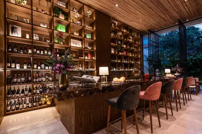 a bar with a bunch of bottles of wine at Elcielo Hotel Luxury Medellin in Medellín