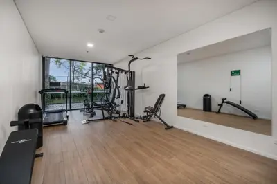 a gym with treadmills and machines in a room at Olive Living Suites by HOUSY in Envigado