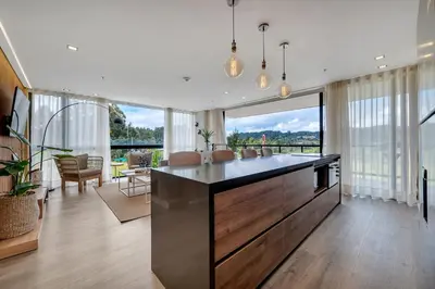 a kitchen with a large island in a living room at Olive Living Suites by HOUSY in Envigado