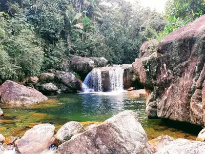 a waterfall in the middle of a river with rocks at Casa Amarilla, San Carlos, Antioquia in San Carlos