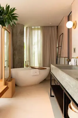 a bathroom with a large tub and a large sink at 23 Hotel Medellin in Medellín