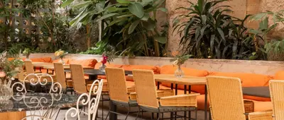 a row of tables and chairs in a restaurant at 23 Hotel Medellin in Medellín
