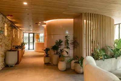 a hallway with potted plants in a building at 23 Hotel Medellin in Medellín