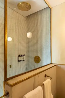 a bathroom with a shower with a mirror and a sink at 23 Hotel Medellin in Medellín