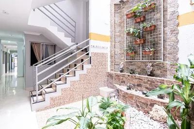a brick wall with potted plants on it at Hotel El Deportista in Medellín