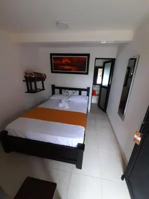 a bedroom with two beds in a room at Hotel San Felipe Belalcazar in Belcazar Caldas