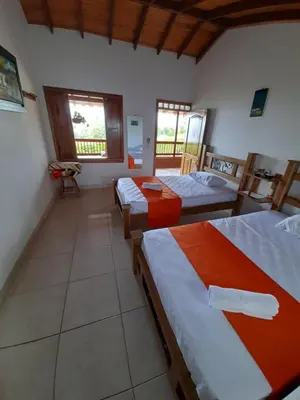 a bedroom with three beds in a room at Hotel San Felipe Belalcazar in Belcazar Caldas