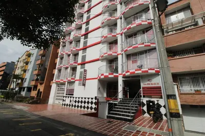 a tall white building with stairs in front of it at Hotel zandalo medellin in Medellín