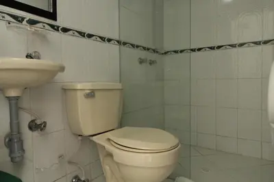 a bathroom with a toilet and a sink at Hotel zandalo medellin in Medellín