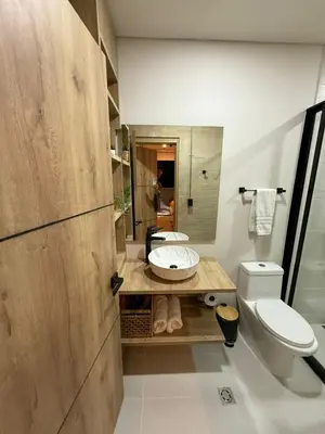 a bathroom with a white toilet and a sink at Manila Hotel Boutique in Medellín