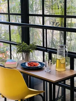 a table with a plate of food and a drink at Manila Hotel Boutique in Medellín