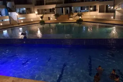 a large swimming pool in a building at night at Condominio vacacional Paraiso del Sol, San Jeronim in San Jerónimo
