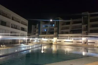 a swimming pool in front of a building at night at Condominio vacacional Paraiso del Sol, San Jeronim in San Jerónimo