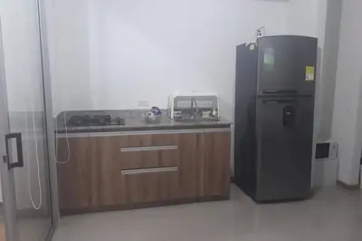 a kitchen with a black refrigerator and a counter at Condominio vacacional Paraiso del Sol, San Jeronim in San Jerónimo