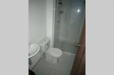 a bathroom with a white toilet and a shower at Condominio vacacional Paraiso del Sol, San Jeronim in San Jerónimo