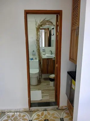 a bathroom with a sink and a toilet and a mirror at Hotel Bahia Del Faro in Guatapé