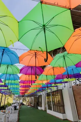 a bunch of colorful umbrellas hanging from a building at Hotel Bahia Del Faro in Guatapé